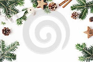 Christmas festive styled stock composition. Decorative floral frame. Fir tree branches border. Pine cones, wooden stars