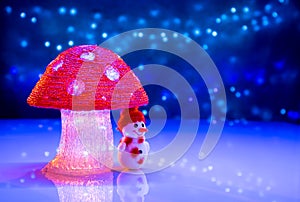 Christmas figures. Snowman under a big mushroom.