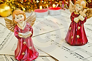 Christmas figurine of angels on a music sheet.