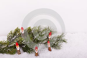 Christmas fir branch with Santa Claus in the snow