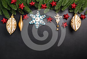 Christmas fir branches with decorations on a black background