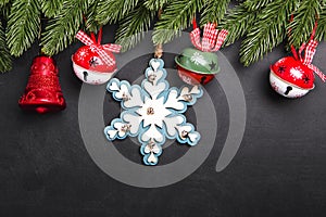 Christmas fir branches with decorations on a black background