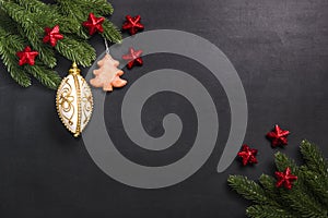 Christmas fir branches with decorations on a black background