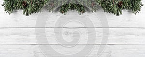 Christmas Fir branches with pine cones on white wooden background. Xmas and Happy New Year theme. Flat lay, top view