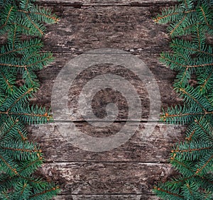 Christmas Fir branches on wooden background. Xmas and Happy New Year theme.