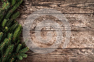 Christmas fir branches on wooden background. Xmas and New Year theme.