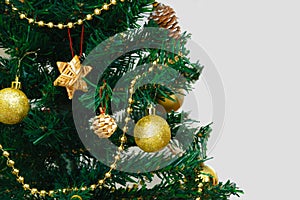 Christmas fir tree with balls and serpentine closeup. White background