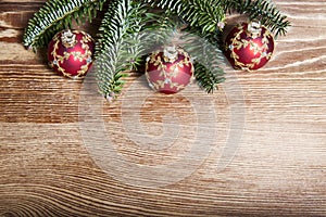Christmas fir tree with baubles on rustic wooden board