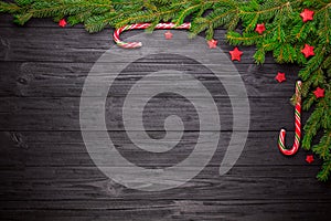 Christmas fir tree on black wooden background