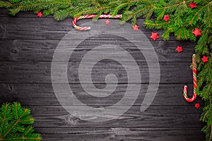 Christmas fir tree on black wooden background