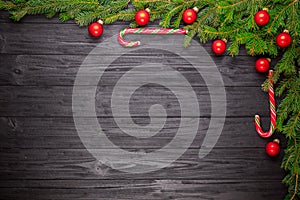 Christmas fir tree on black wooden background