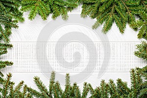 Christmas fir tree branch frame over white wood