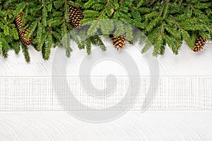 Christmas fir tree branch frame over white wood