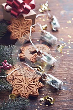 Christmas fir tree branches, Christmas balls, Christmas gingerbread, gift box, snowflakes and stars on old wooden background for x