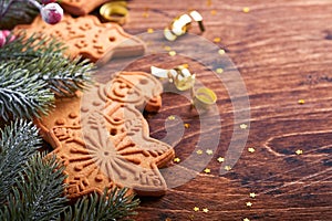 Christmas fir tree branches, Christmas balls, Christmas gingerbread, gift box, snowflakes and stars on old wooden background for x