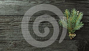 Christmas fir tree branches and pine cones on wooden dark, black background