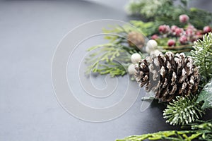 Christmas fir tree branches, winter background border over gray board, copy space. Winter greeting card, winter holidays photo