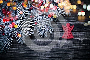 Christmas fir tree with decoration on dark wooden background