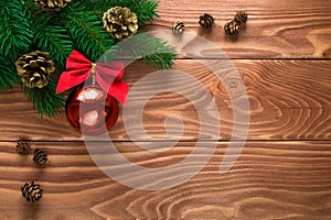 Christmas fir tree with decoration on dark wooden board. Soft focus.