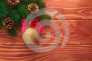 Christmas fir tree with decoration on dark wooden board. Soft focus.