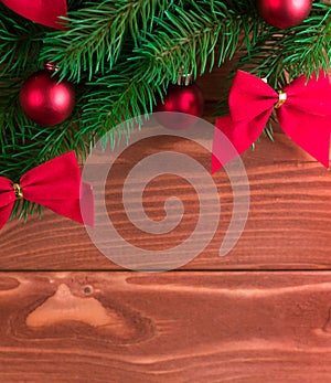 Christmas fir tree with decoration on dark wooden board. Soft focus.