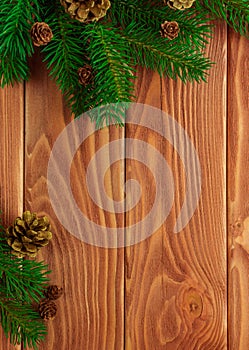 Christmas fir tree with decoration on dark wooden board. Soft focus.