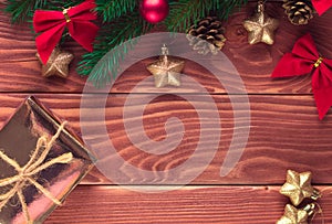 Christmas fir tree with decoration on dark wooden board. Soft focus.