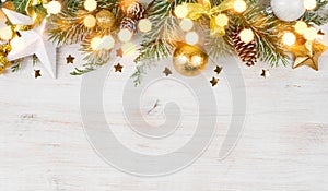 Christmas fir tree with decoration and glitters on wooden background