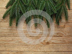 Christmas fir tree with decoration on wooden board background with copy space