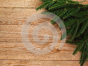 Christmas fir tree with decoration on wooden board background with copy space