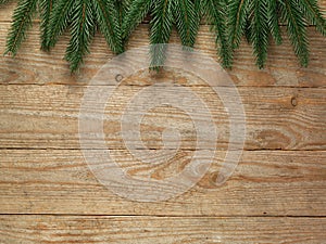 Christmas fir tree with decoration on wooden board background with copy space