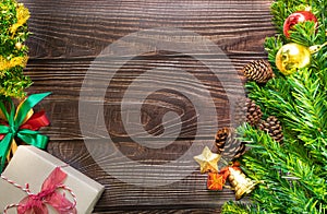 Christmas fir tree, festive. Composition decorations and xmas gift boxes on dark wooden board background. Celebration for holiday