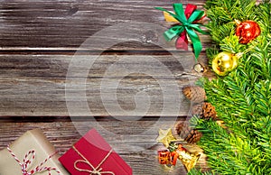Christmas fir tree, festive. Composition decorations and xmas gift boxes on dark wooden board background. Celebration for holiday