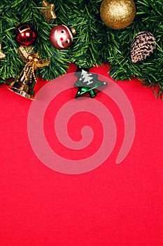 Christmas fir tree with ornament ball decoration on red background. Flat lay. Top view. Christmas background.