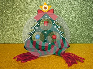 Christmas fir-tree in a warm woolen scarf