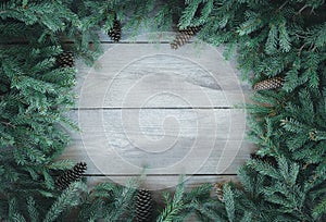 Christmas Firbranch with cones on old wooden rustic background with copy space for text.