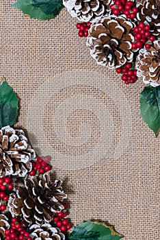 Christmas flat-lay arrangement pinecones, red berries and holly leaves