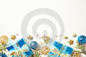 Christmas flat lay composition with luxury gifts, blue and gold balls and decorations, for branches on white background