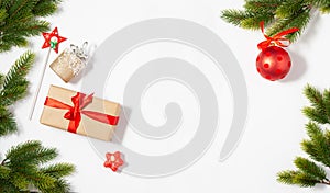 Christmas flat lay frame with copy space mockup. Present box and fir tree branches composition on the white background