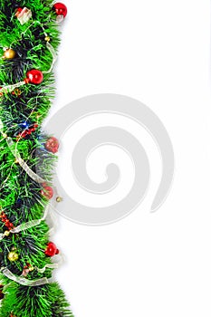 Green tinsel with red and gold balls on a white background