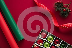 Christmas flatlay and holiday design concept. Decoration, ornament and xmas gift wrapping on red paper background as