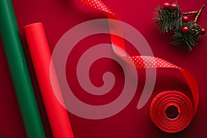 Christmas flatlay and holiday design concept. Decoration, ornament and xmas gift wrapping on red paper background as