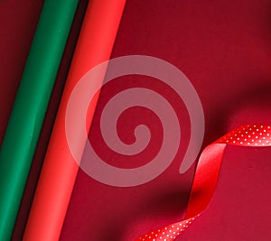 Christmas flatlay and holiday design concept. Decoration, ornament and xmas gift wrapping on red paper background as