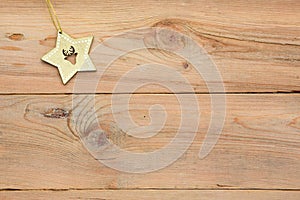 Christmas flatlay on a wooden background in rustic style: decorations made of wood in the shape of a star, spruce.