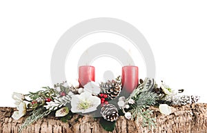 Christmas floral arrangement with bark, branches and red candles on white