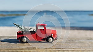 Christmas in Florida theme, red toy truck hauls a christmas tat Lake Louisa State Park in Clermont, Florida
