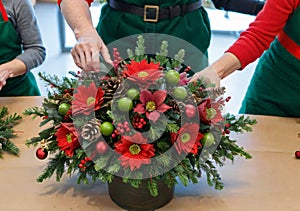 A Christmas Flower Arrangement Class, With Festive Bouquets On A Table. Generative AI