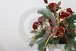 A Christmas Flower Bouquet off Fancy Red Flowers with some Christmas Tree Branches.