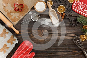 Christmas food background for baking gingerbread cookies with cutters, rolling pin, dough, flour and spices ondark wood photo