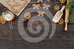 Christmas food background for baking gingerbread cookies with cutters, rolling pin, dough, flour and spices ondark wood table. photo